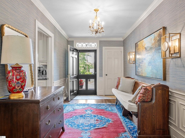 1076 Woodburn Rd, Spartanburg, SC 29302 - entrance foyer with wallpapered walls, a chandelier, crown molding, light wood-style floors, and a wainscoted wall
