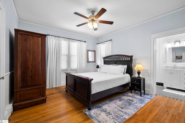 201 W Arlington Ave, Greer, SC 29650 - bedroom with light wood finished floors, crown molding, connected bathroom, ceiling fan, and a sink