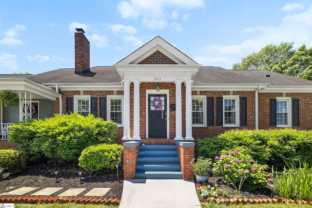 201 W Arlington Ave, Greer, SC 29650 - view of front of property with brick siding, a chimney, and a shingled roof