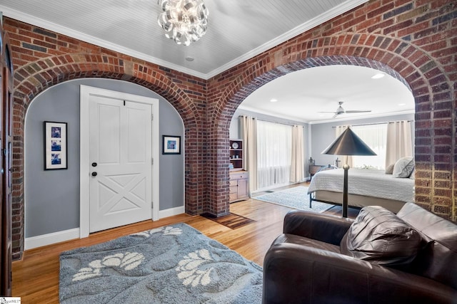 201 W Arlington Ave, Greer, SC 29650 - bedroom with arched walkways, crown molding, baseboards, wood finished floors, and brick wall