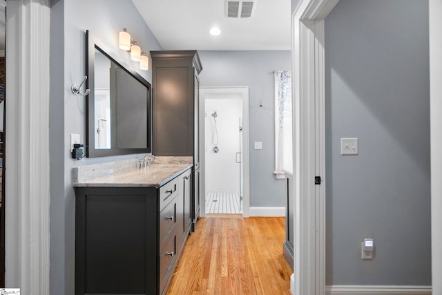 201 W Arlington Ave, Greer, SC 29650 - bathroom with a stall shower, vanity, wood finished floors, and baseboards