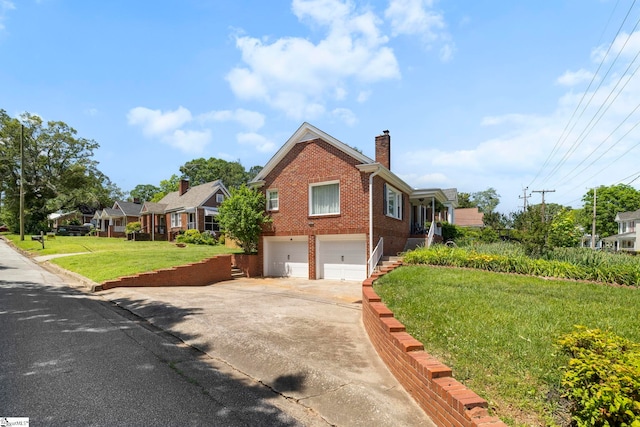 201 W Arlington Ave, Greer, SC 29650 - view of home's exterior with brick siding, an attached garage, a chimney, concrete driveway, and a yard
