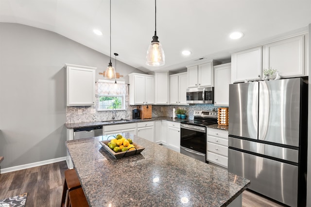 45 Lake Harbor Ct, Greer, SC 29651 - kitchen featuring appliances with stainless steel finishes, lofted ceiling, a sink, decorative backsplash, and white cabinets