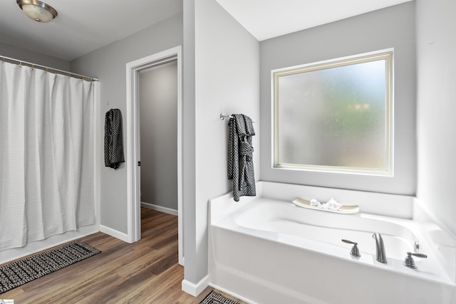 45 Lake Harbor Ct, Greer, SC 29651 - bathroom with a bath, baseboards, wood finished floors, and a shower with curtain