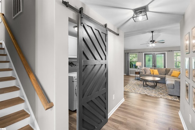 45 Lake Harbor Ct, Greer, SC 29651 - stairway featuring a barn door, ceiling fan, wood finished floors, washer / clothes dryer, and baseboards