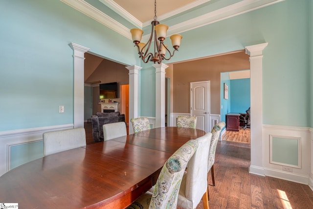 202 Buxton Ct, Easley, SC 29642 - dining area with ornate columns, a wainscoted wall, wood finished floors, crown molding, and a fireplace