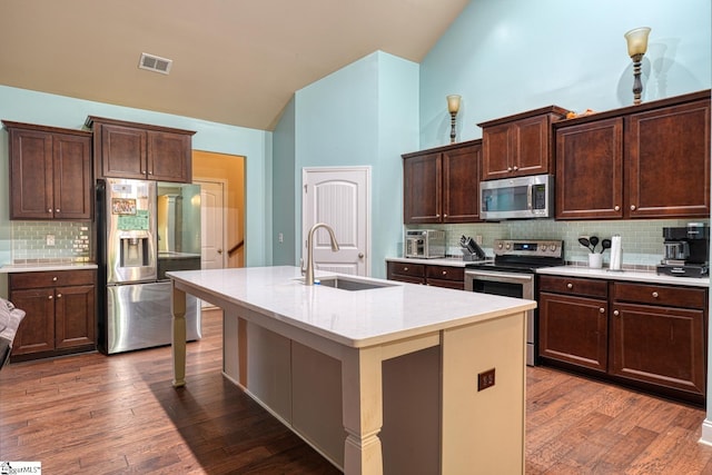 202 Buxton Ct, Easley, SC 29642 - kitchen with stainless steel appliances, a sink, backsplash, dark brown cabinetry, and an island with sink