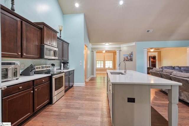 202 Buxton Ct, Easley, SC 29642 - kitchen with stainless steel appliances, a sink, open floor plan, and dark brown cabinetry