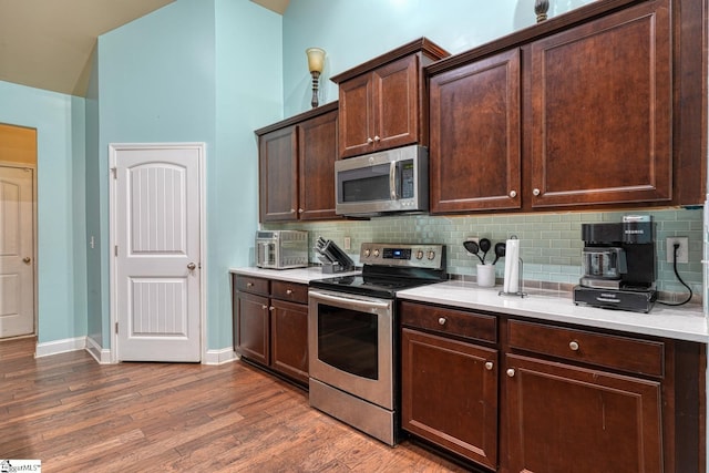 202 Buxton Ct, Easley, SC 29642 - kitchen featuring stainless steel appliances, light countertops, tasteful backsplash, dark brown cabinets, and dark wood finished floors