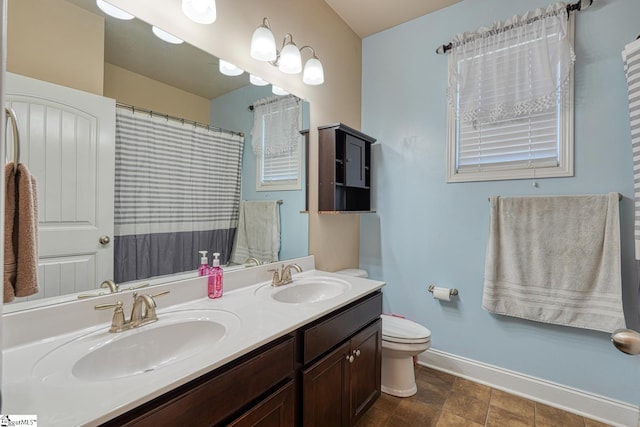 202 Buxton Ct, Easley, SC 29642 - bathroom featuring baseboards, double vanity, toilet, and curtained shower