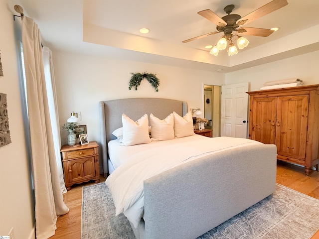 6050 Cross Anchor Rd, Enoree, SC 29335 - bedroom with light wood-type flooring, a raised ceiling, recessed lighting, and ceiling fan