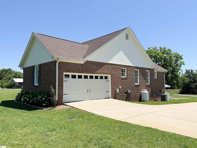 6050 Cross Anchor Rd, Enoree, SC 29335 - view of side of home featuring central AC unit, concrete driveway, an attached garage, brick siding, and a yard