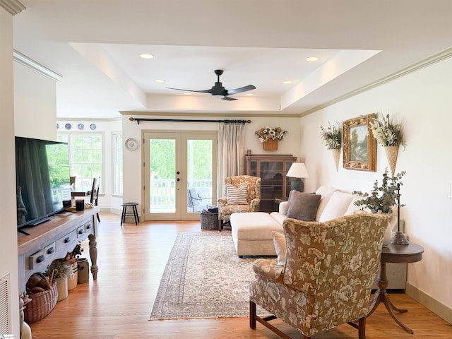 6050 Cross Anchor Rd, Enoree, SC 29335 - living room with a tray ceiling, plenty of natural light, light wood-style flooring, french doors, and crown molding