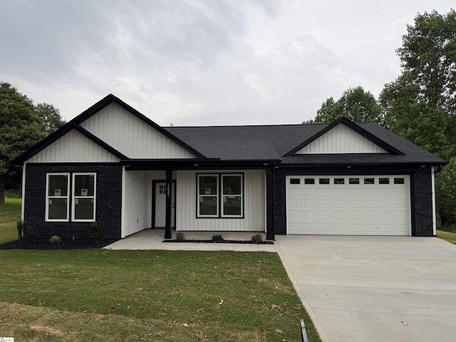 1623 Fairfield Rd, Chesnee, SC 29323 - view of front facade with an attached garage, driveway, a front yard, covered porch, and roof with shingles