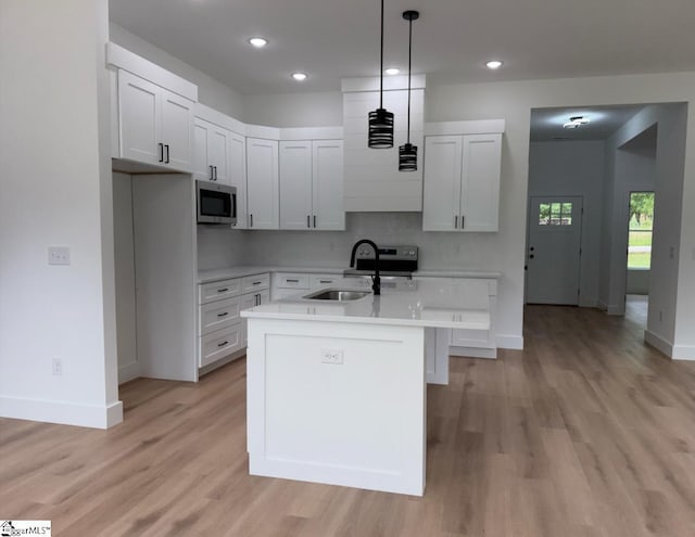 1623 Fairfield Rd, Chesnee, SC 29323 - kitchen featuring a sink, stainless steel microwave, baseboards, light wood-style flooring, and recessed lighting