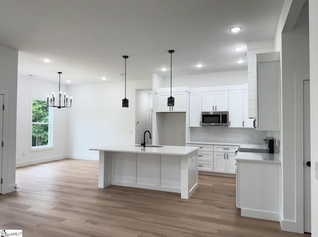 1623 Fairfield Rd, Chesnee, SC 29323 - kitchen featuring stainless steel microwave, a sink, electric stove, backsplash, and light wood finished floors