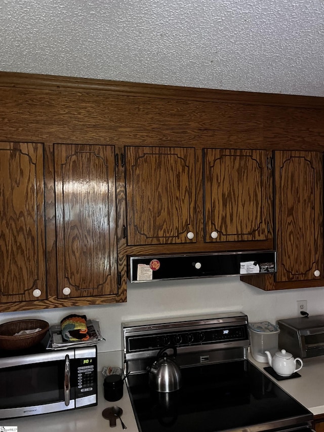 106 Stonegate Ct, Simpsonville, SC 29681 - kitchen featuring electric range oven, stainless steel microwave, range hood, and dark brown cabinetry