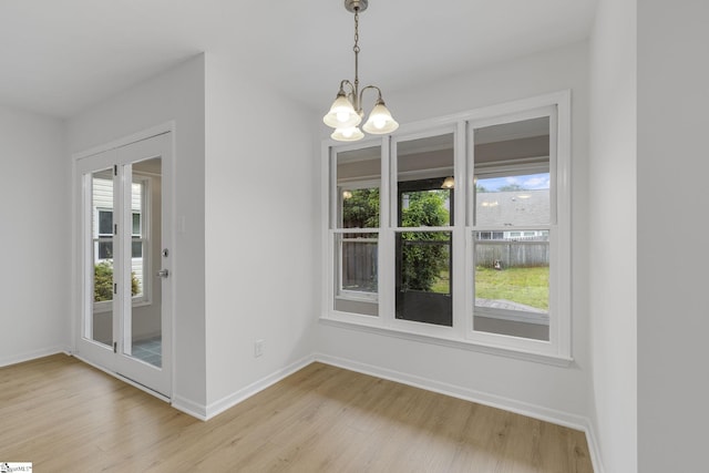 528 Market St, Spartanburg, SC 29301 - unfurnished dining area featuring a chandelier, light wood-type flooring, and baseboards