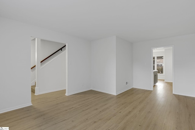 528 Market St, Spartanburg, SC 29301 - unfurnished room featuring light wood-style flooring, stairway, and baseboards