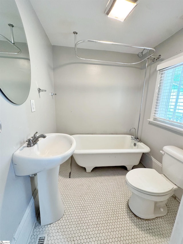 203 Arlington Rd, Greer, SC 29651 - bathroom with toilet, a sink, and a combined bath / shower with freestanding tub