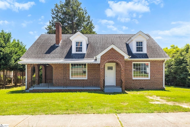 202 E Green St, Iva, SC 29655 - view of front facade featuring a front yard, brick siding, and a chimney