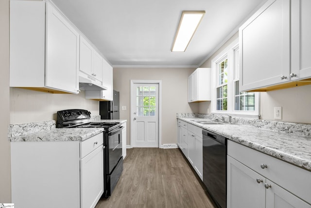 202 E Green St, Iva, SC 29655 - kitchen featuring black / electric stove, dishwasher, under cabinet range hood, light wood-type flooring, and a sink