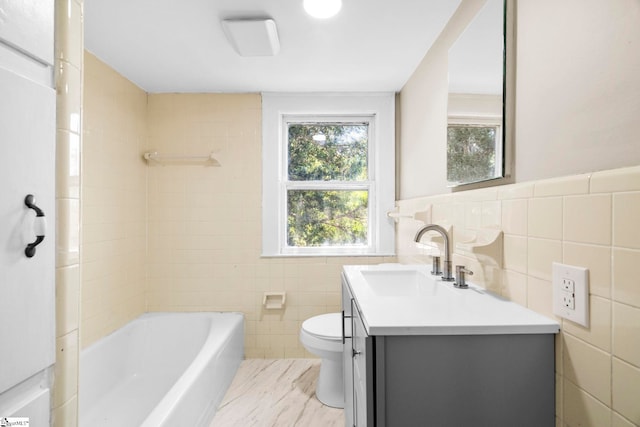 202 E Green St, Iva, SC 29655 - full bathroom featuring tile walls, toilet, vanity, a wainscoted wall, and bathing tub / shower combination