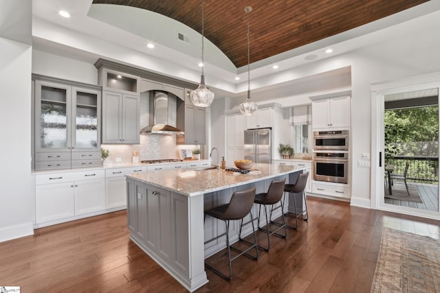 1110 Mountain Summit Rd, Travelers Rest, SC 29690 - kitchen with stainless steel appliances, wall chimney exhaust hood, vaulted ceiling, wooden ceiling, and a kitchen breakfast bar