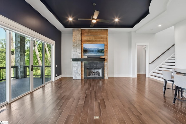 1110 Mountain Summit Rd, Travelers Rest, SC 29690 - unfurnished living room with a fireplace, a tray ceiling, stairway, wood finished floors, and baseboards