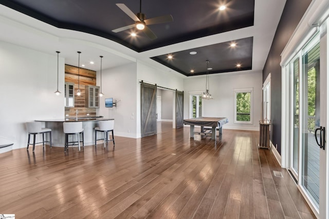 1110 Mountain Summit Rd, Travelers Rest, SC 29690 - playroom featuring a barn door, dark wood-style floors, a tray ceiling, baseboards, and ceiling fan