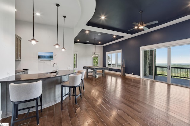 1110 Mountain Summit Rd, Travelers Rest, SC 29690 - kitchen featuring a sink, dark wood-style flooring, a kitchen breakfast bar, ceiling fan, and pendant lighting