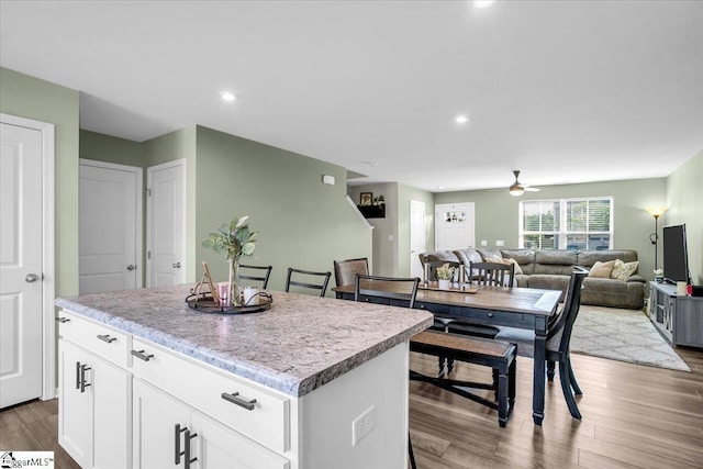275 Ralston Rd, Greer, SC 29651 - kitchen featuring a center island, ceiling fan, wood finished floors, white cabinetry, and light countertops