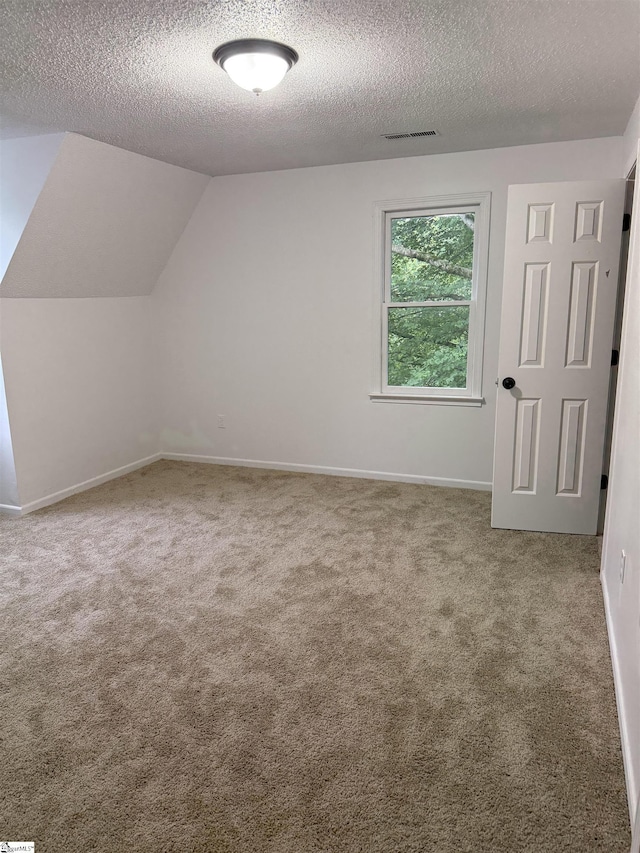 122 Franklin Dr, Central, SC 29630 - bonus room with a textured ceiling, carpet floors, baseboards, and vaulted ceiling