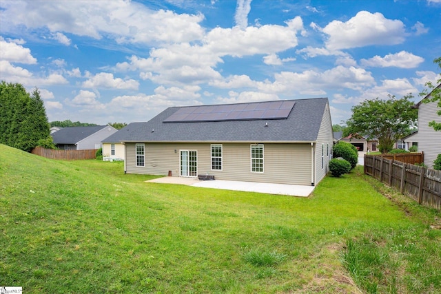 124 Bascom Ct, Greer, SC 29650 - back of property featuring a patio, roof mounted solar panels, and a shingled roof