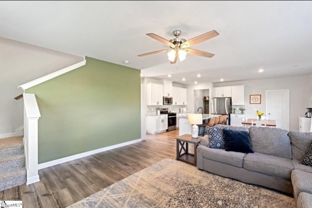 1019 Appalachian Dr, Moore, SC 29369 - living area featuring light wood-type flooring, ceiling fan, stairway, recessed lighting, and baseboards
