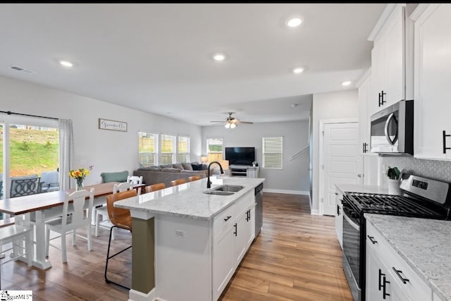 1019 Appalachian Dr, Moore, SC 29369 - kitchen with stainless steel appliances, a sink, ceiling fan, a kitchen island with sink, and recessed lighting