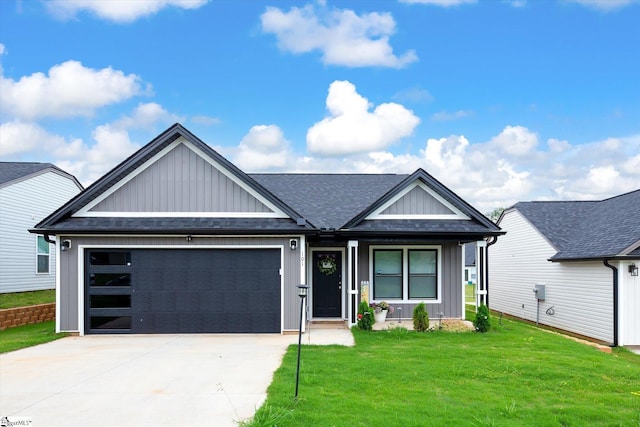 101 Sunrise Rd, Spartanburg, SC 29302 - view of front of house with board and batten siding, a garage, driveway, a front lawn, and a shingled roof