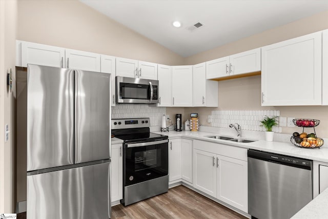 101 Sunrise Rd, Spartanburg, SC 29302 - kitchen with stainless steel appliances, a sink, white cabinets, vaulted ceiling, and recessed lighting