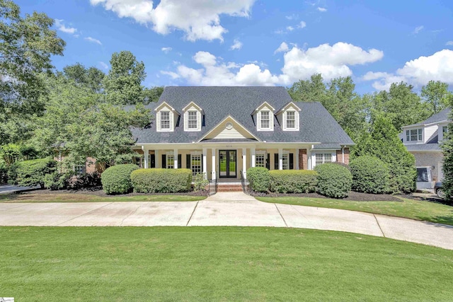604 Shefwood Dr, Easley, SC 29642 - cape cod home with a front yard, covered porch, brick siding, roof with shingles, and french doors