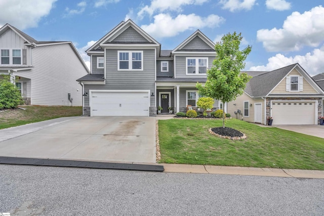 113 Marshfield Trl, Simpsonville, SC 29680 - craftsman inspired home with concrete driveway, a front yard, an attached garage, covered porch, and stone siding