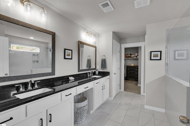113 Marshfield Trl, Simpsonville, SC 29680 - full bath featuring a tile shower, double vanity, a walk in closet, marble finish floors, and baseboards