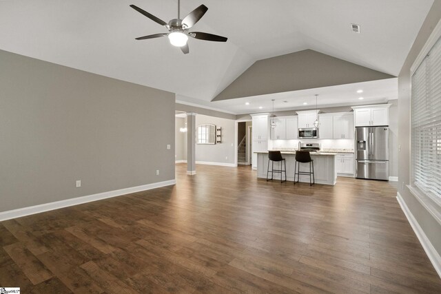 116 Woodstone Dr, Easley, SC 29642 - unfurnished living room featuring a ceiling fan, vaulted ceiling, dark wood finished floors, baseboards, and recessed lighting