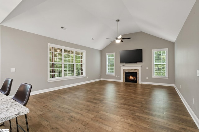 116 Woodstone Dr, Easley, SC 29642 - living area with dark wood-type flooring, vaulted ceiling, a ceiling fan, a lit fireplace, and baseboards