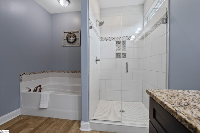 116 Woodstone Dr, Easley, SC 29642 - bathroom with a stall shower, a garden tub, wood finished floors, vanity, and baseboards