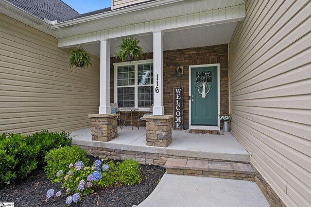 116 Woodstone Dr, Easley, SC 29642 - entrance to property with covered porch, roof with shingles, and stone siding