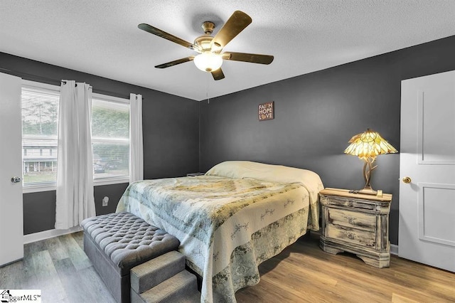 469 Royal Oak Dr, Spartanburg, SC 29302 - bedroom featuring wood finished floors, a textured ceiling, ceiling fan, and baseboards