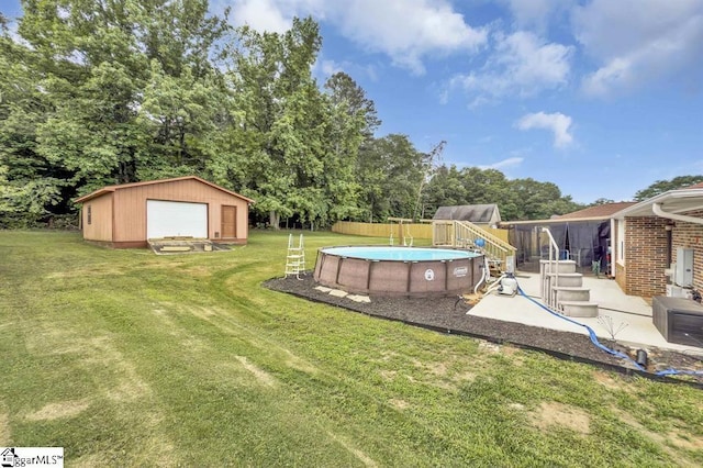 469 Royal Oak Dr, Spartanburg, SC 29302 - view of yard with a detached garage, an outdoor structure, an outdoor pool, and view of wooded area