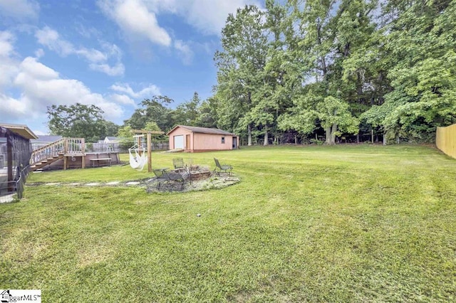 469 Royal Oak Dr, Spartanburg, SC 29302 - view of yard featuring an outbuilding, an outdoor fire pit, a deck, and view of wooded area