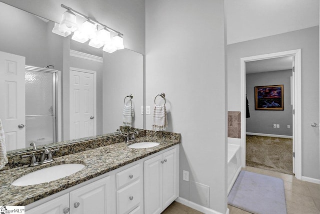 500 E Mountain Creek Rd, Taylors, SC 29687 - full bathroom featuring a stall shower, double vanity, a bath, baseboards, and tile patterned floors