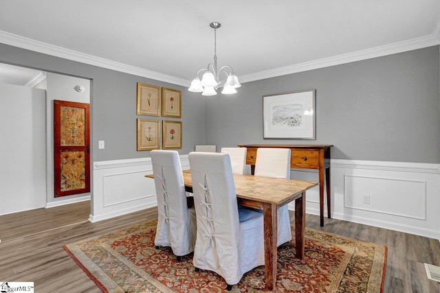 500 E Mountain Creek Rd, Taylors, SC 29687 - dining room with wood finished floors, crown molding, a chandelier, and wainscoting